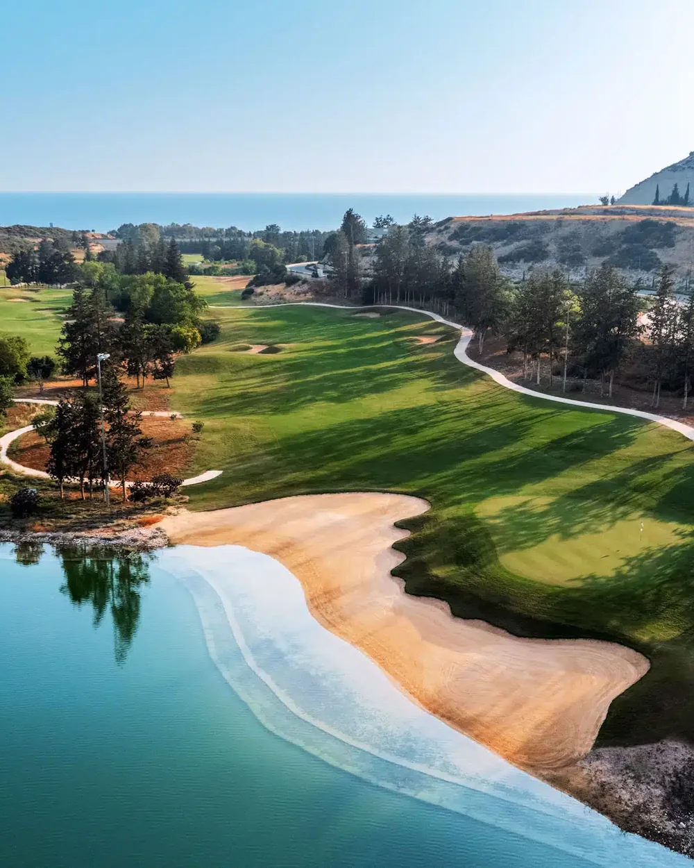 Gated golf-resort community in Paphos with landscaped fairways and Mediterranean backdrop